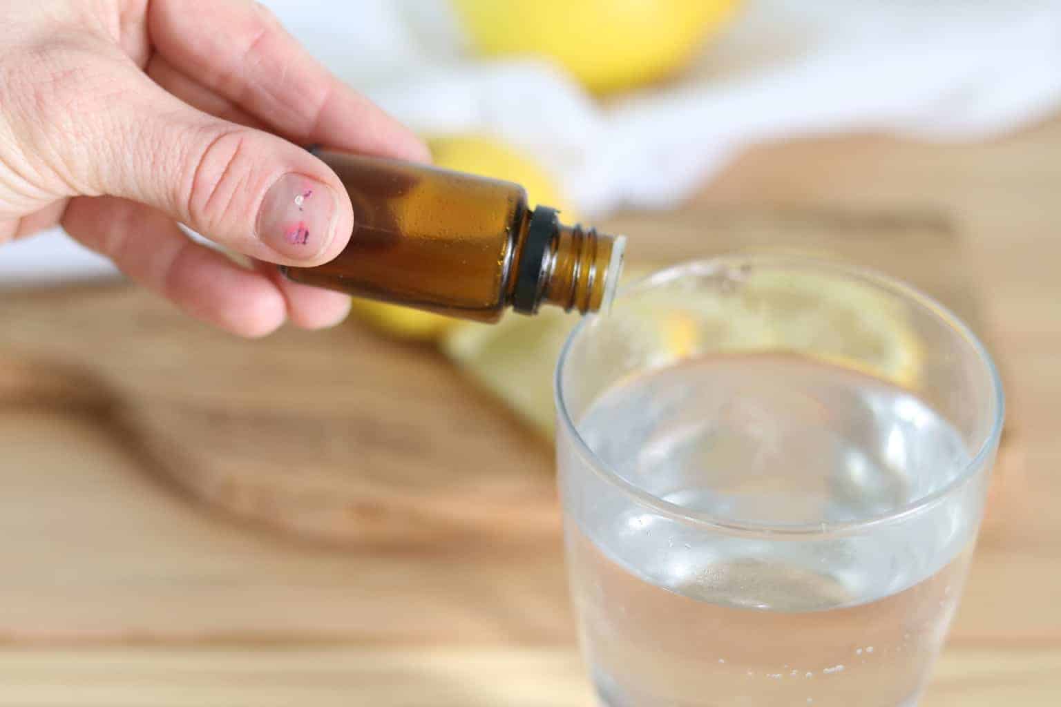 A women poring essential oil into water. 