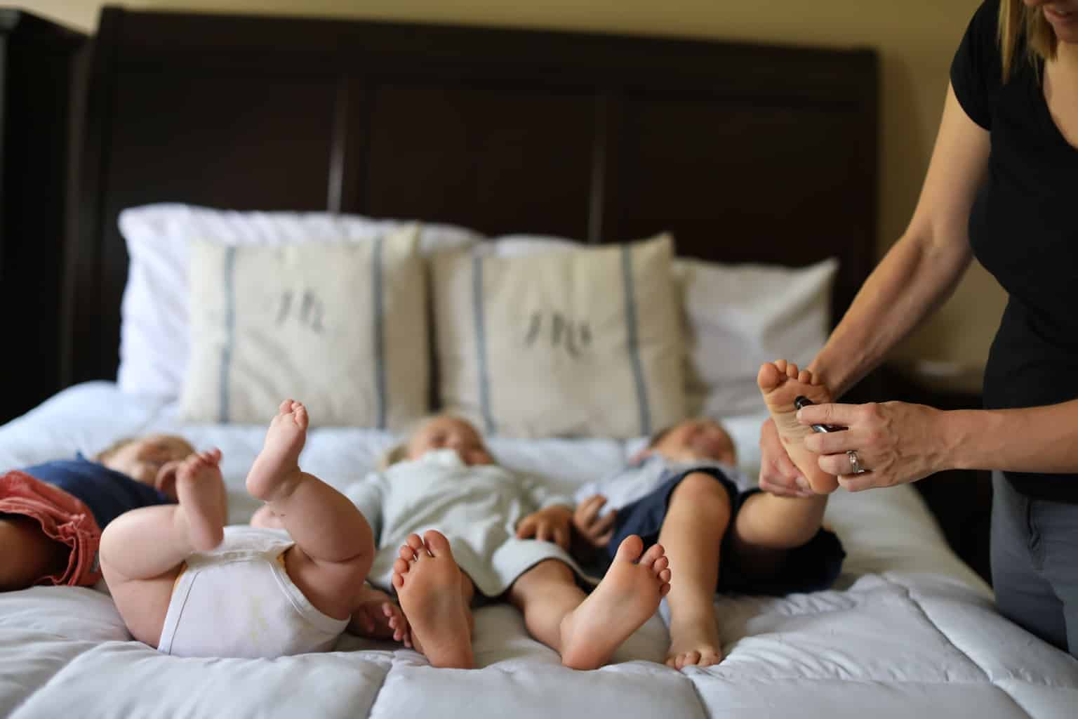 Applying essential oils to children's feet.