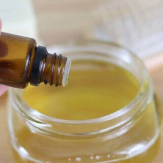 Adding essential oils to melted conditioner ingredients.