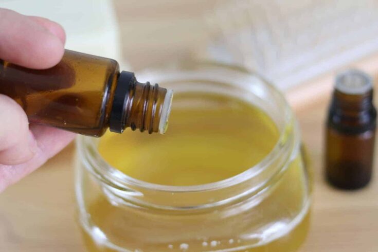 Adding essential oils to melted conditioner ingredients.