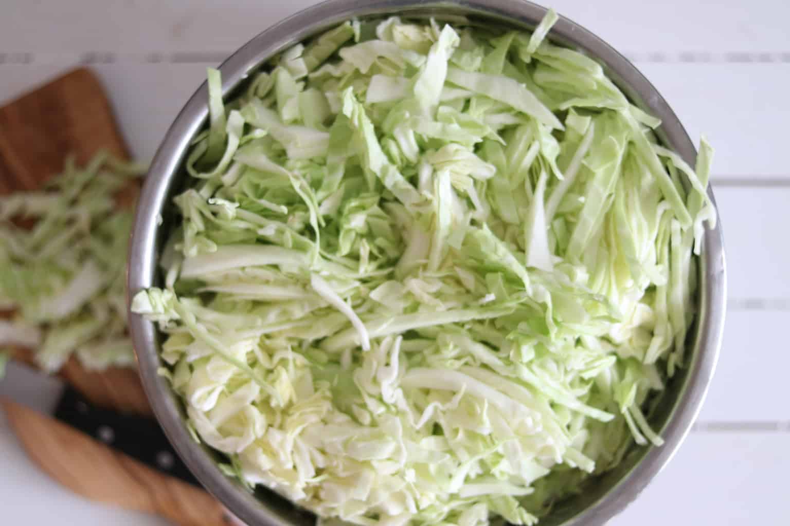 Shredded cabbage in large bowl.