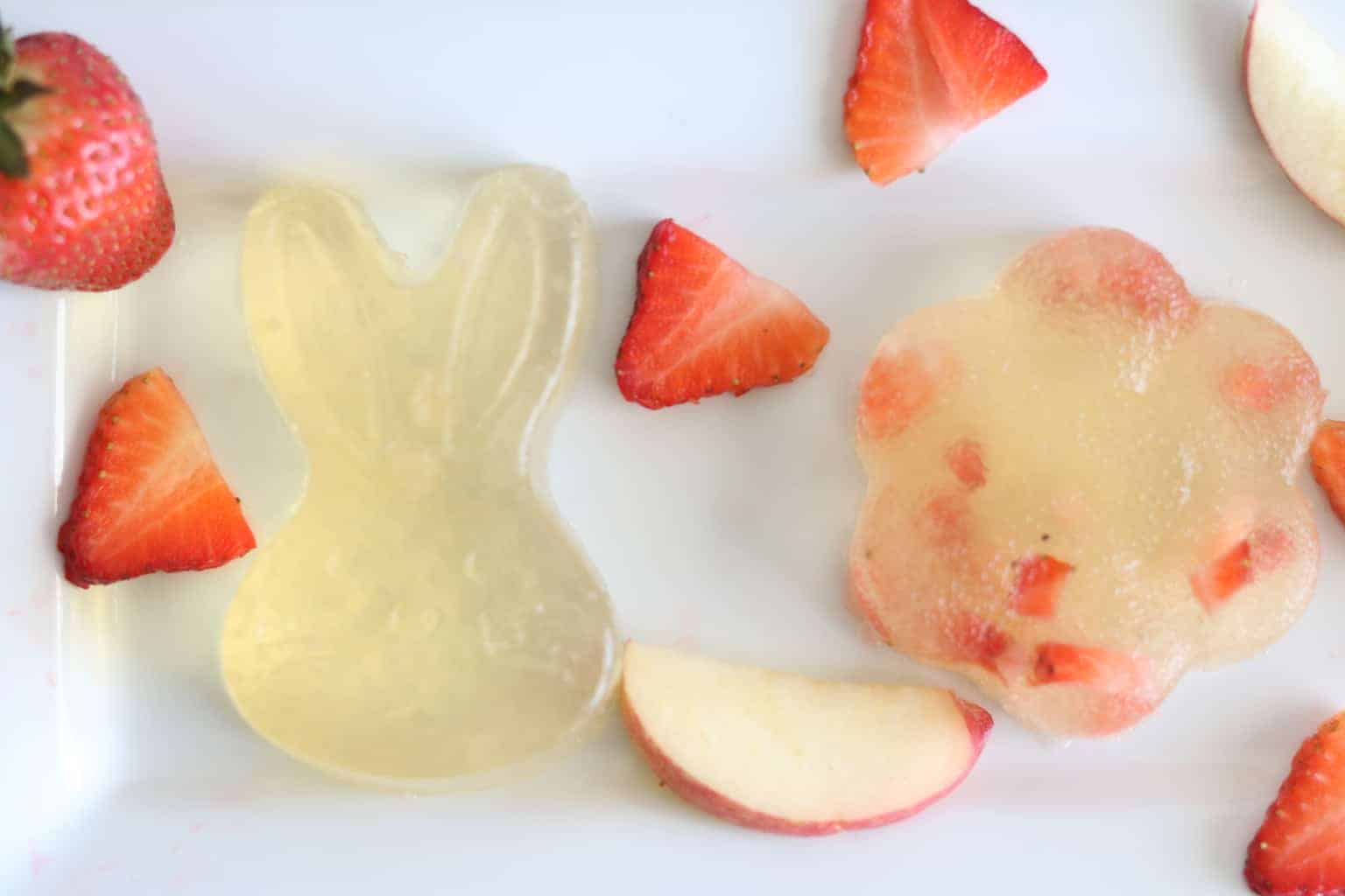 Jello in Easter shapes surrounded by fresh strawberries.