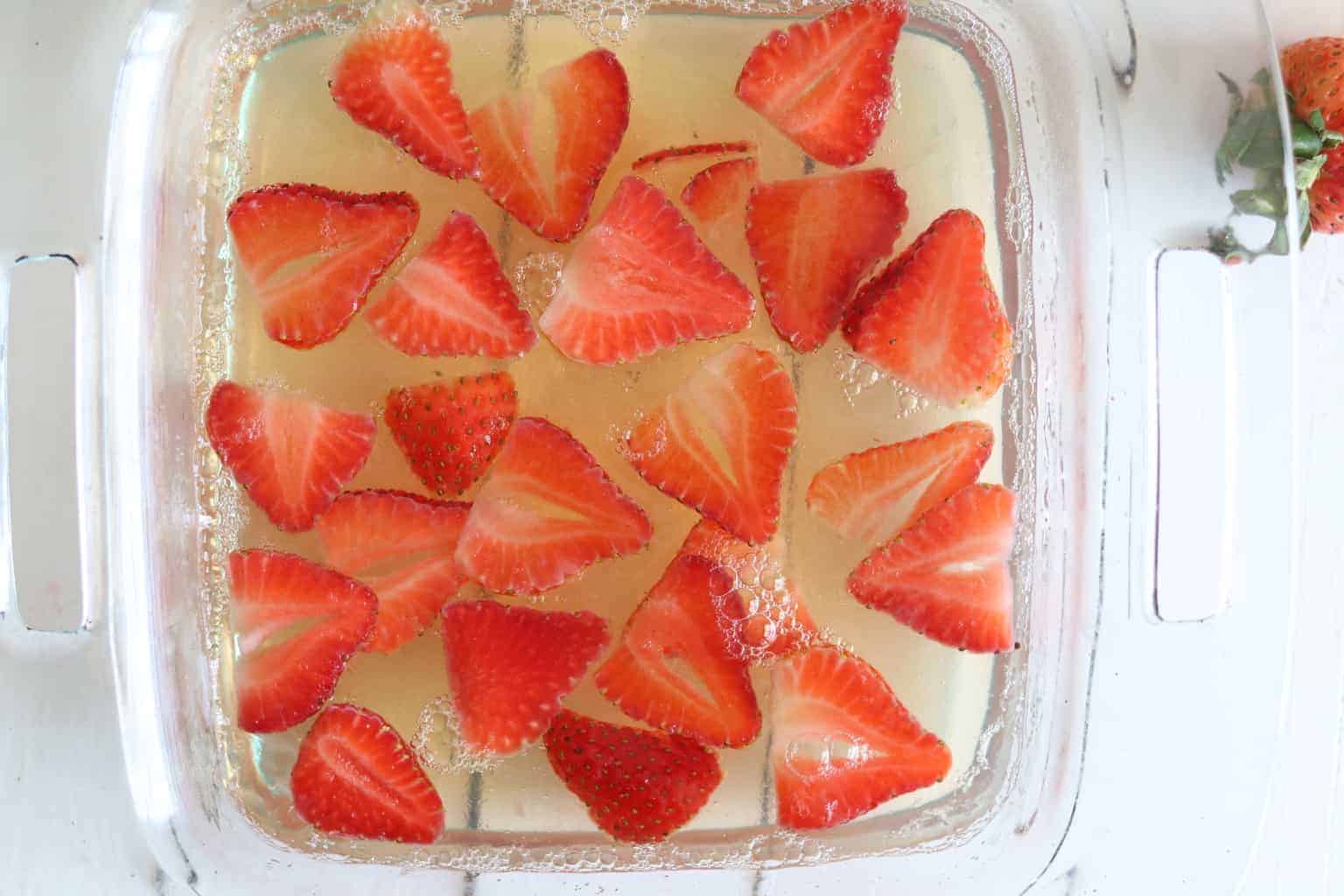 Healthy homemade strawberry jello in baking pan.