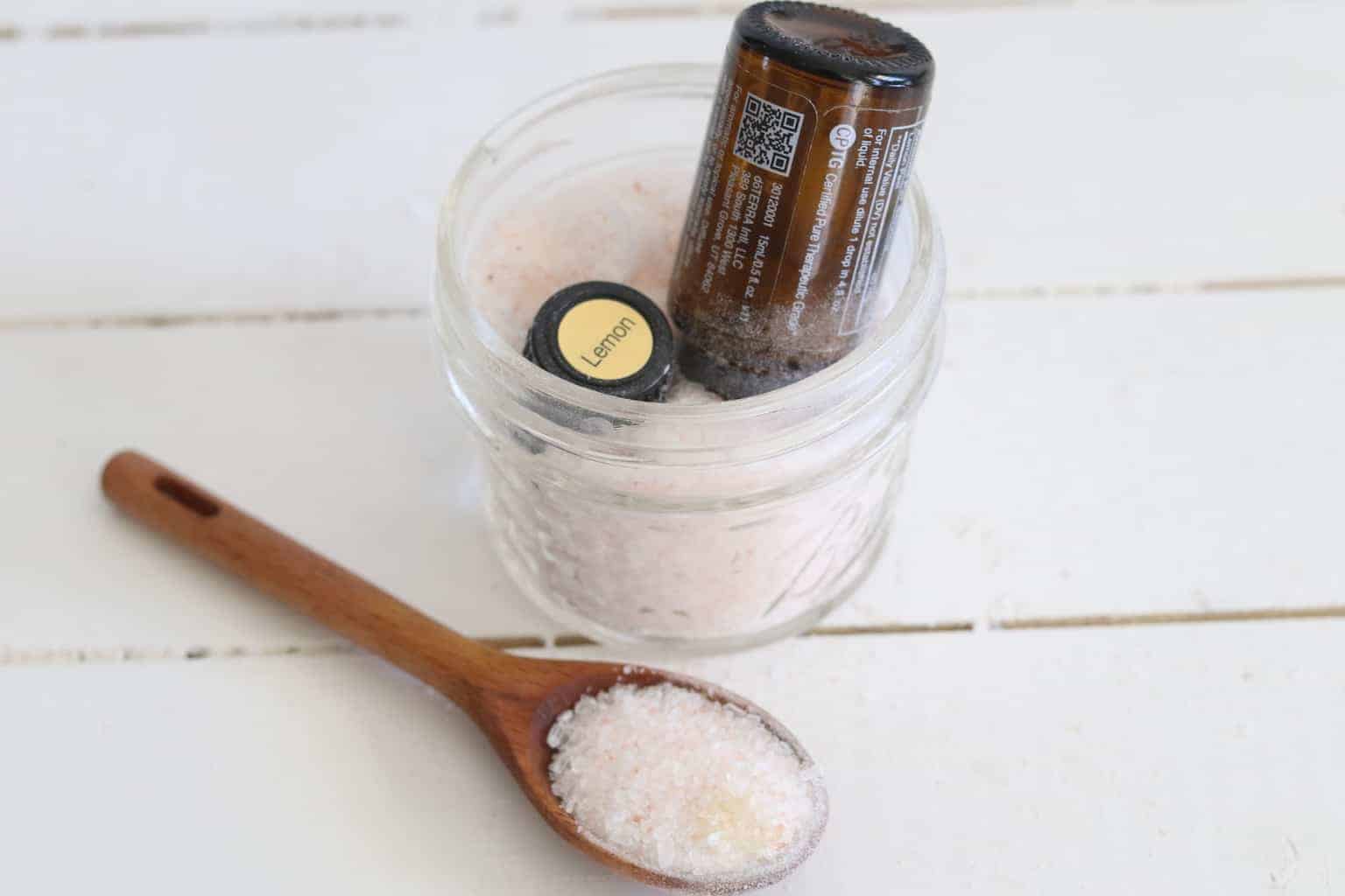 Empty essential oil bottle in salt.