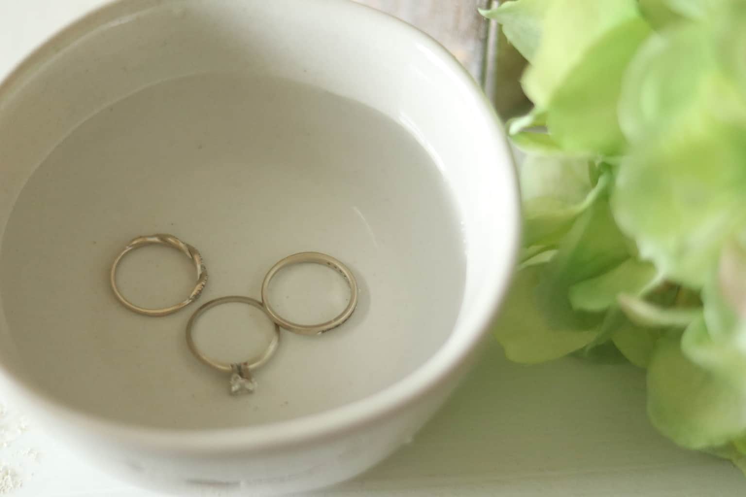 Cleaning rings in homemade jewelry cleaner solution.