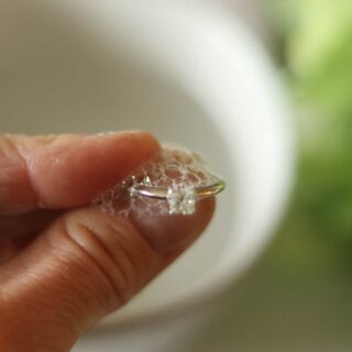 cleaning a diamond ring with soap and water.