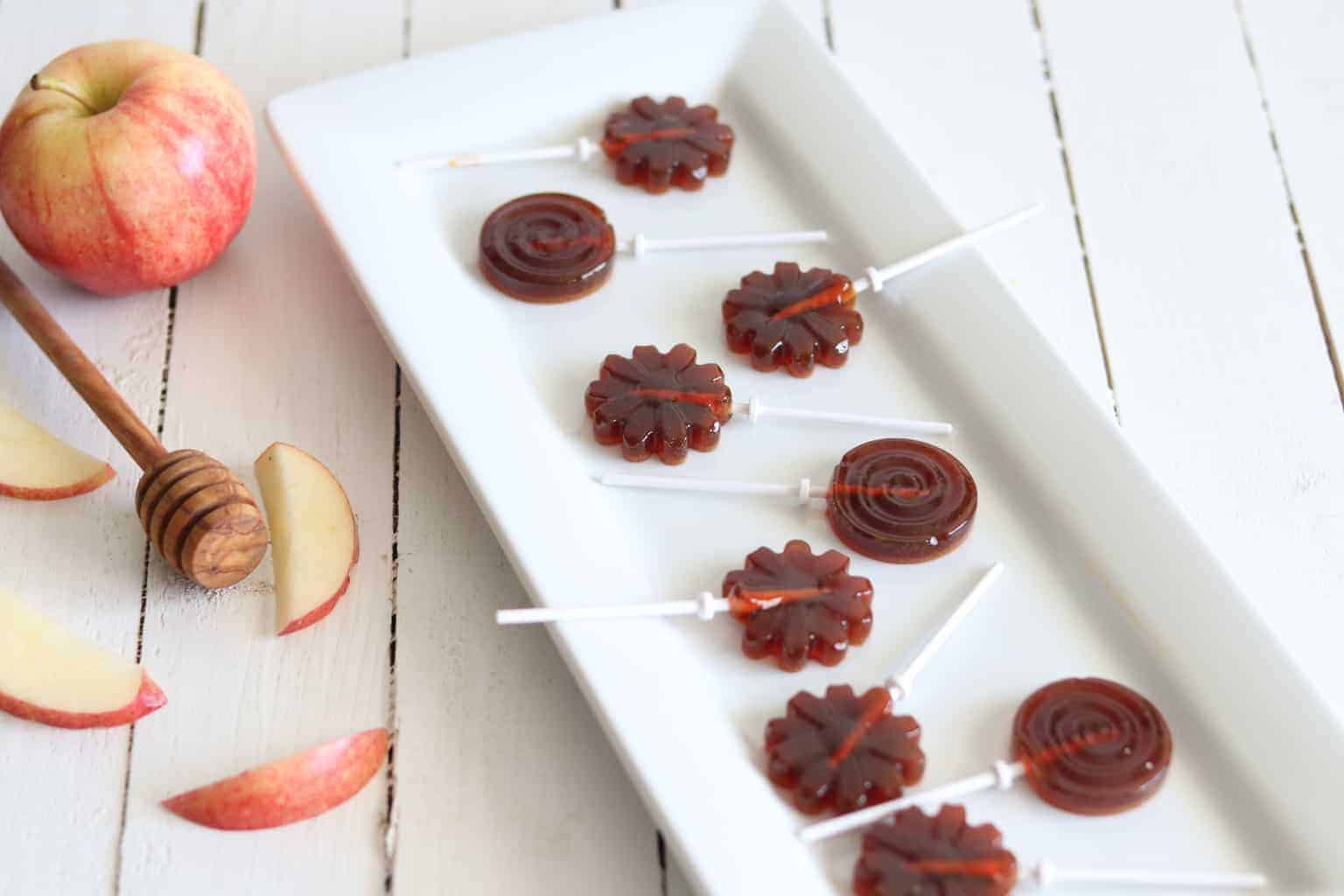 Homemade healthy suckers on white platter.