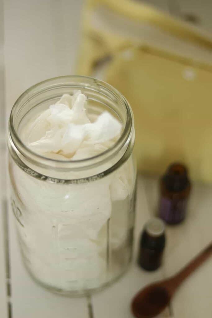 Homemade disposal baby wipes in a glass jar.
