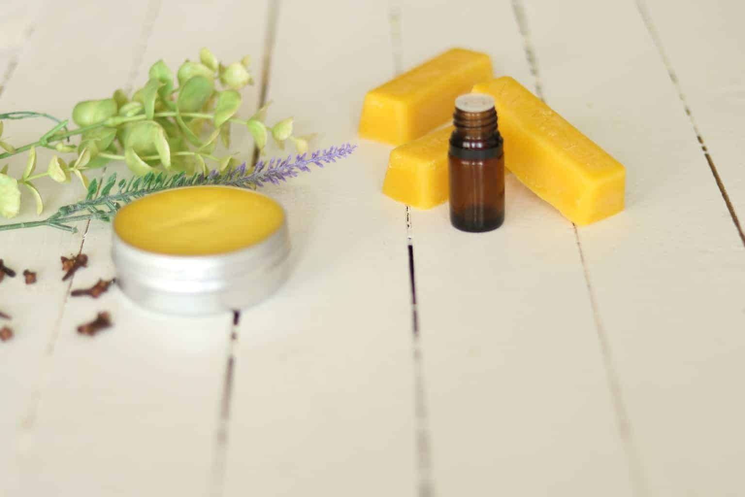 salve beeswax essential oil bottle on white ship lap