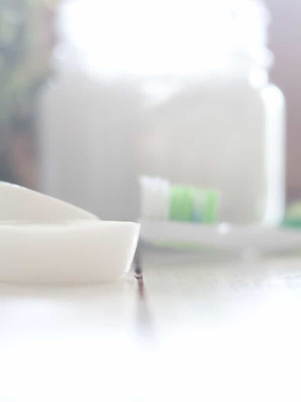 Coconut oil pulling melts on white countertop.