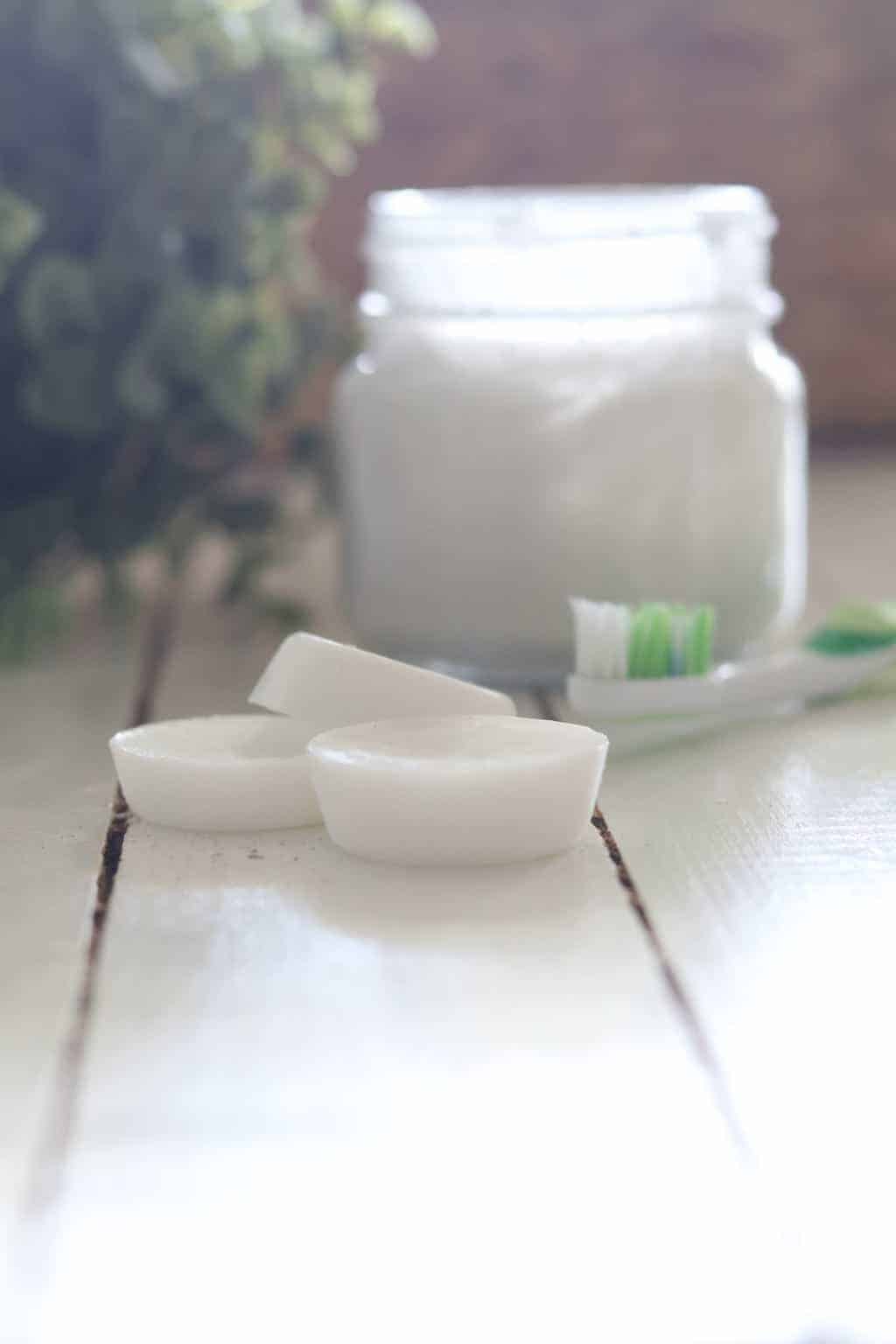 Coconut oil pulling pods on wooden table.