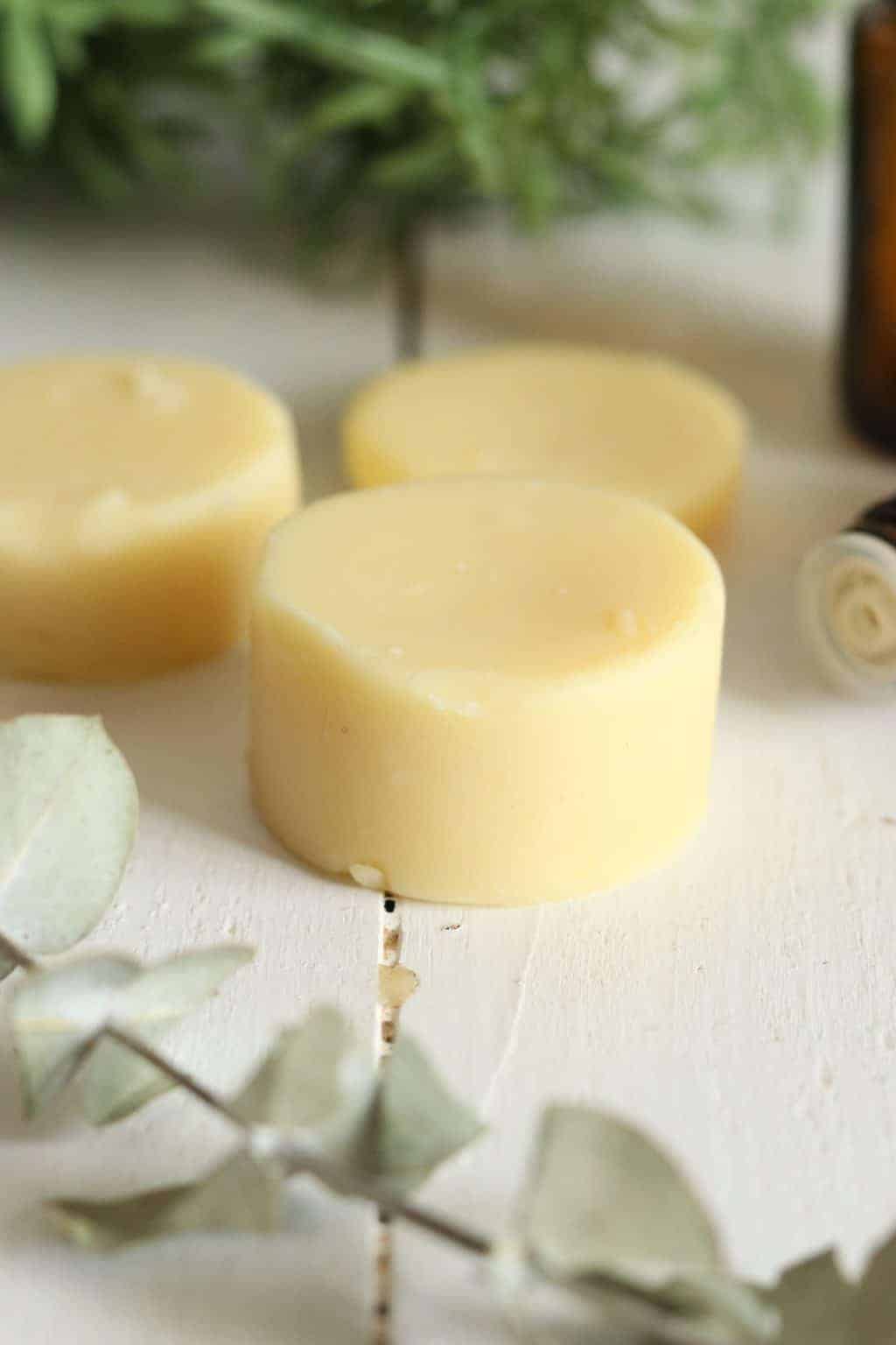 DIY bug repellent lotion bars on white table.