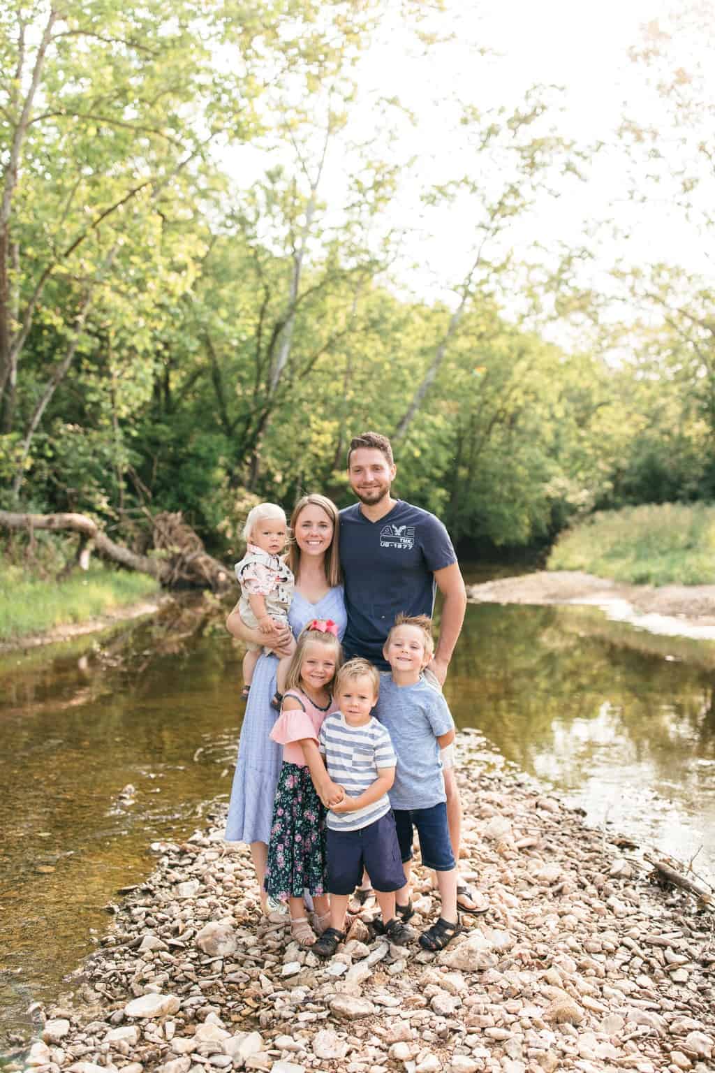 Family picture outside next to creek.
