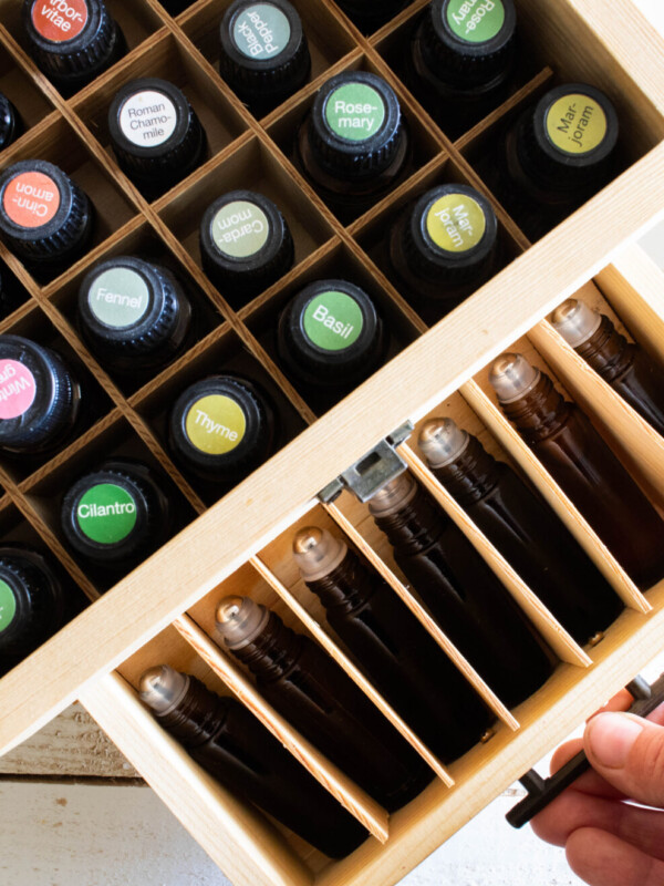 essential oils in wooden storage box on white ship lap