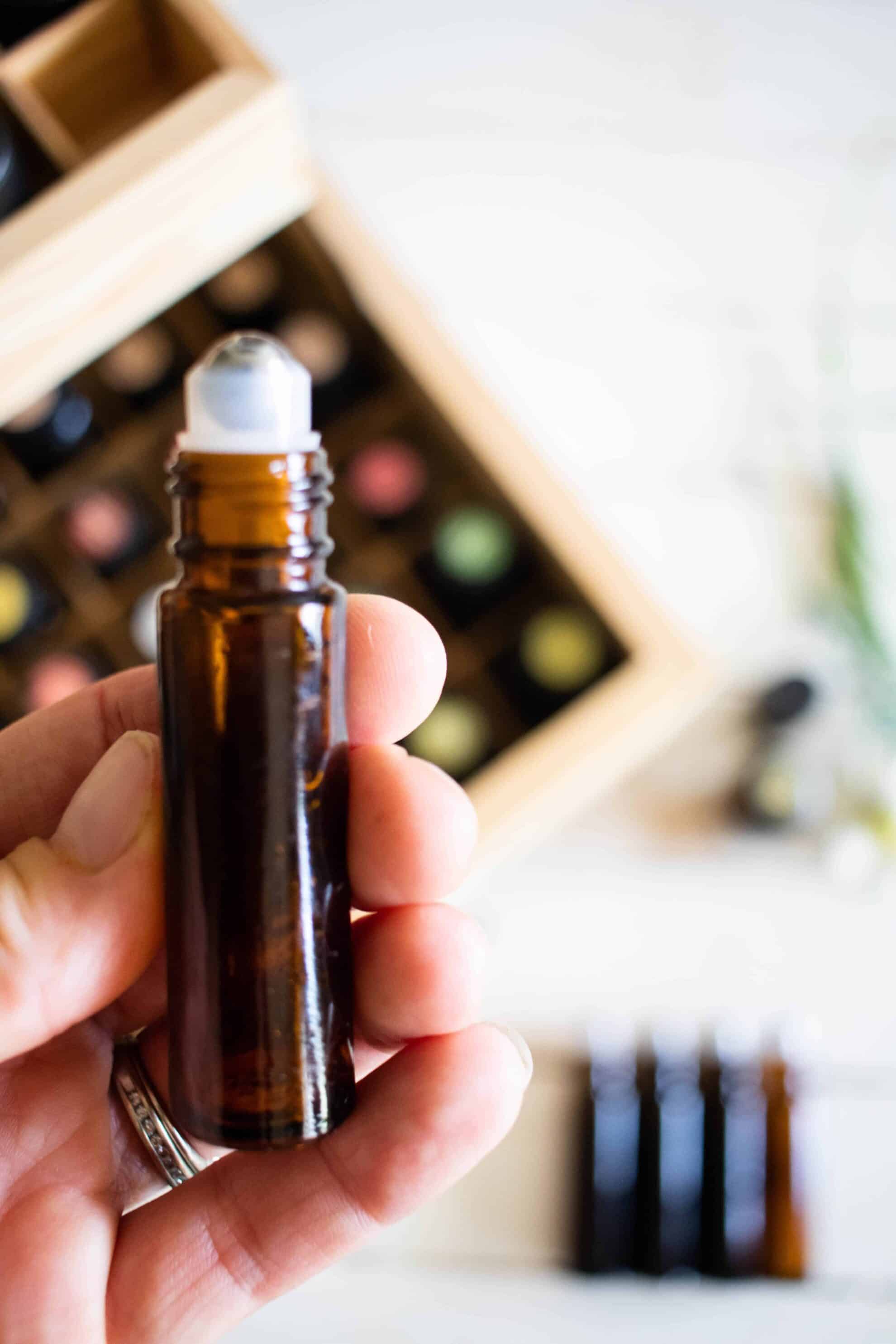 Essential oil roller bottle and wooden storage case.