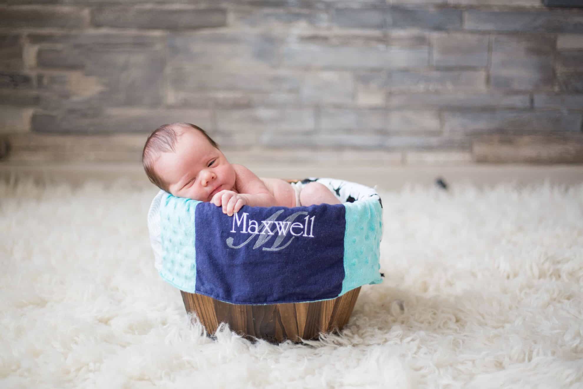 Newborn baby in basket. 