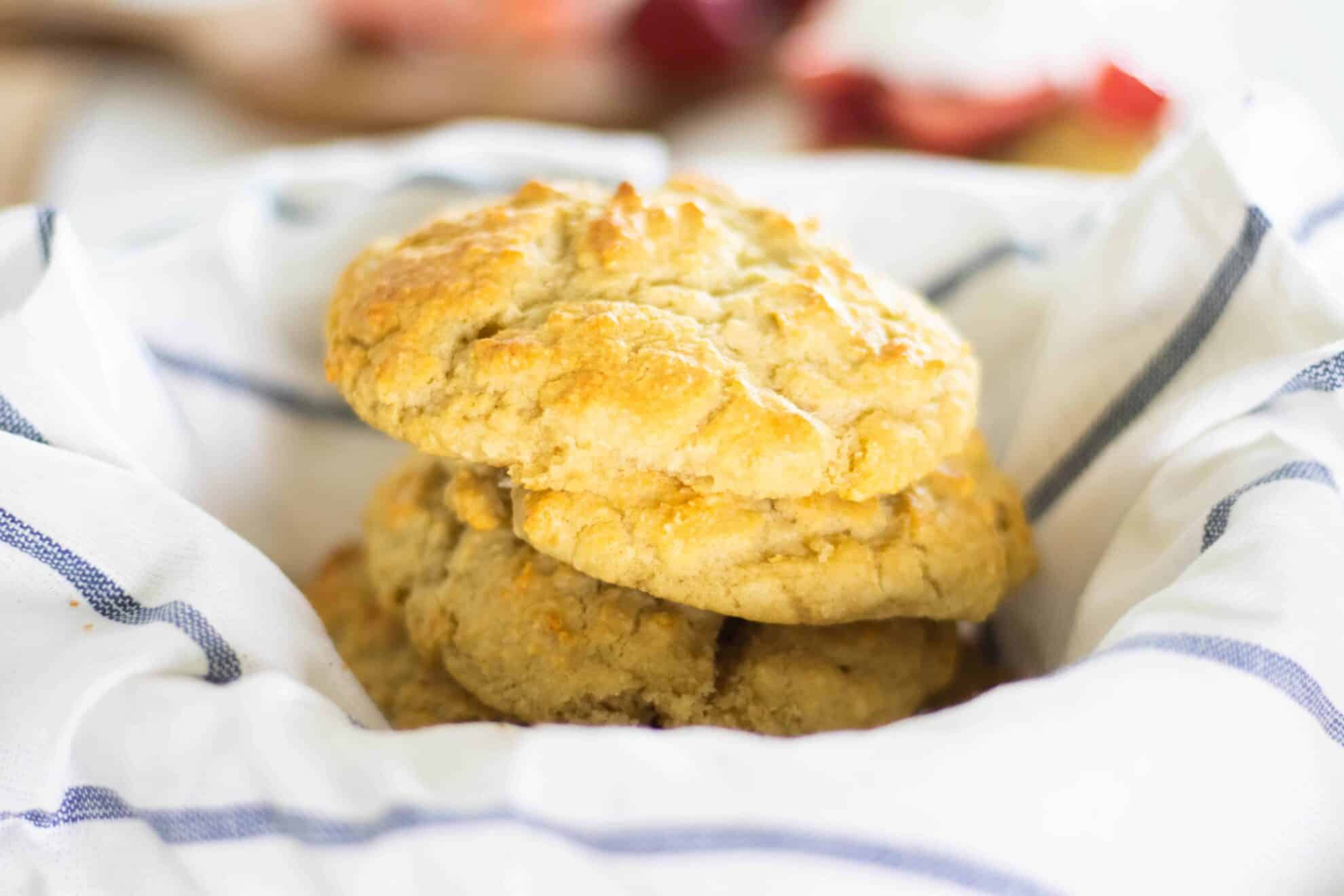 Homemade gluten free biscuits sitting on stripped towel.