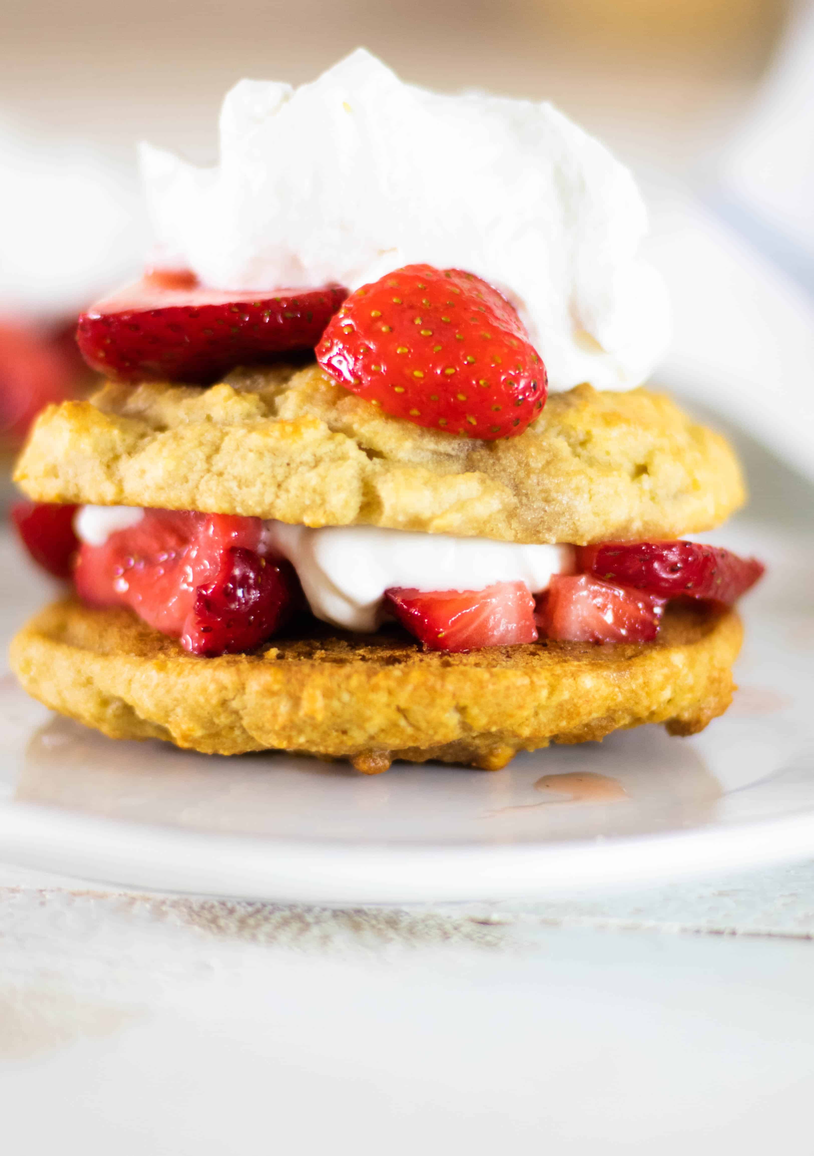 Gluten-free strawberry shortcake with whipped cream and strawberries.