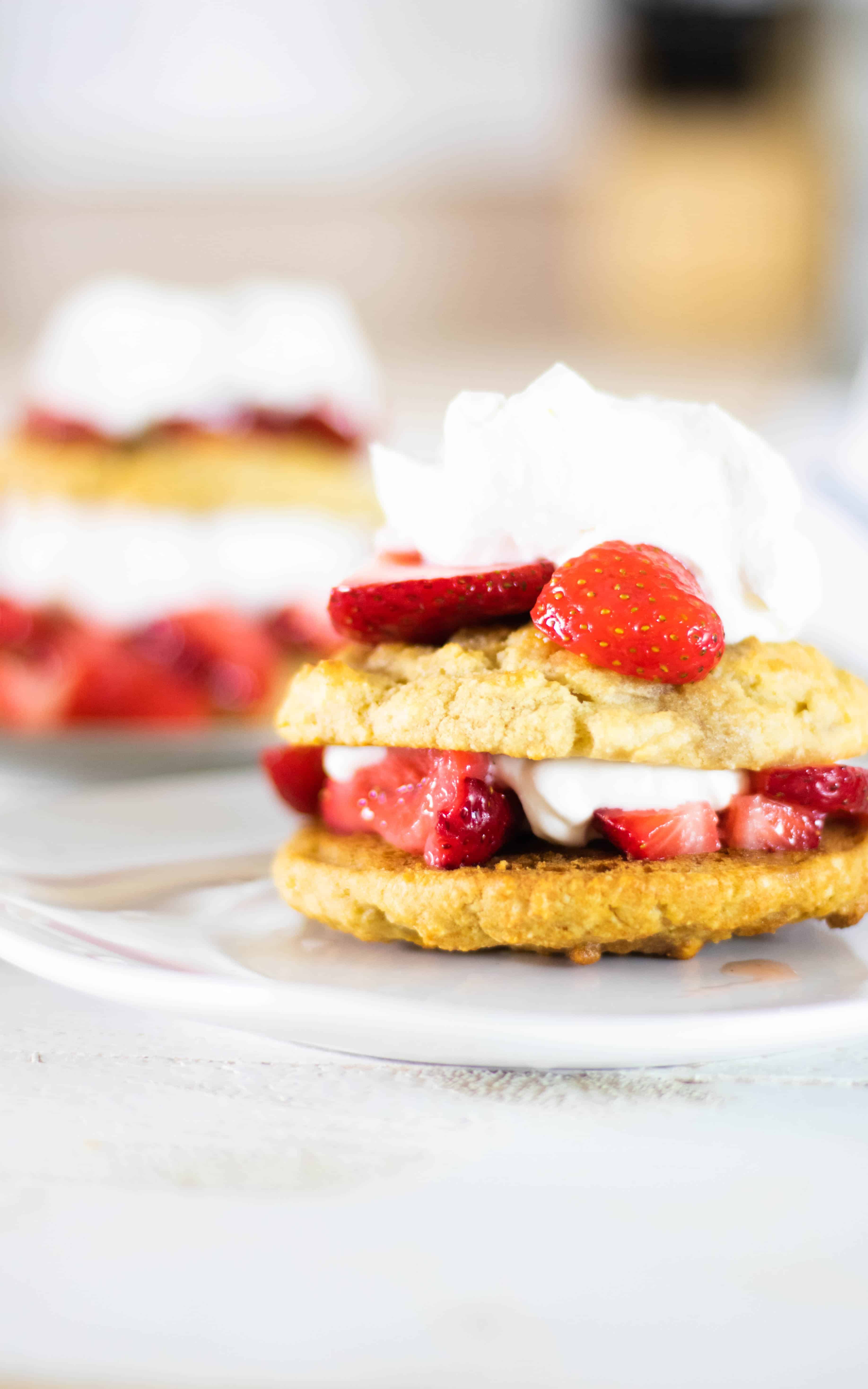 Strawberry shortcakes sandwich topped and filled with whipped cream and fresh strawberries.