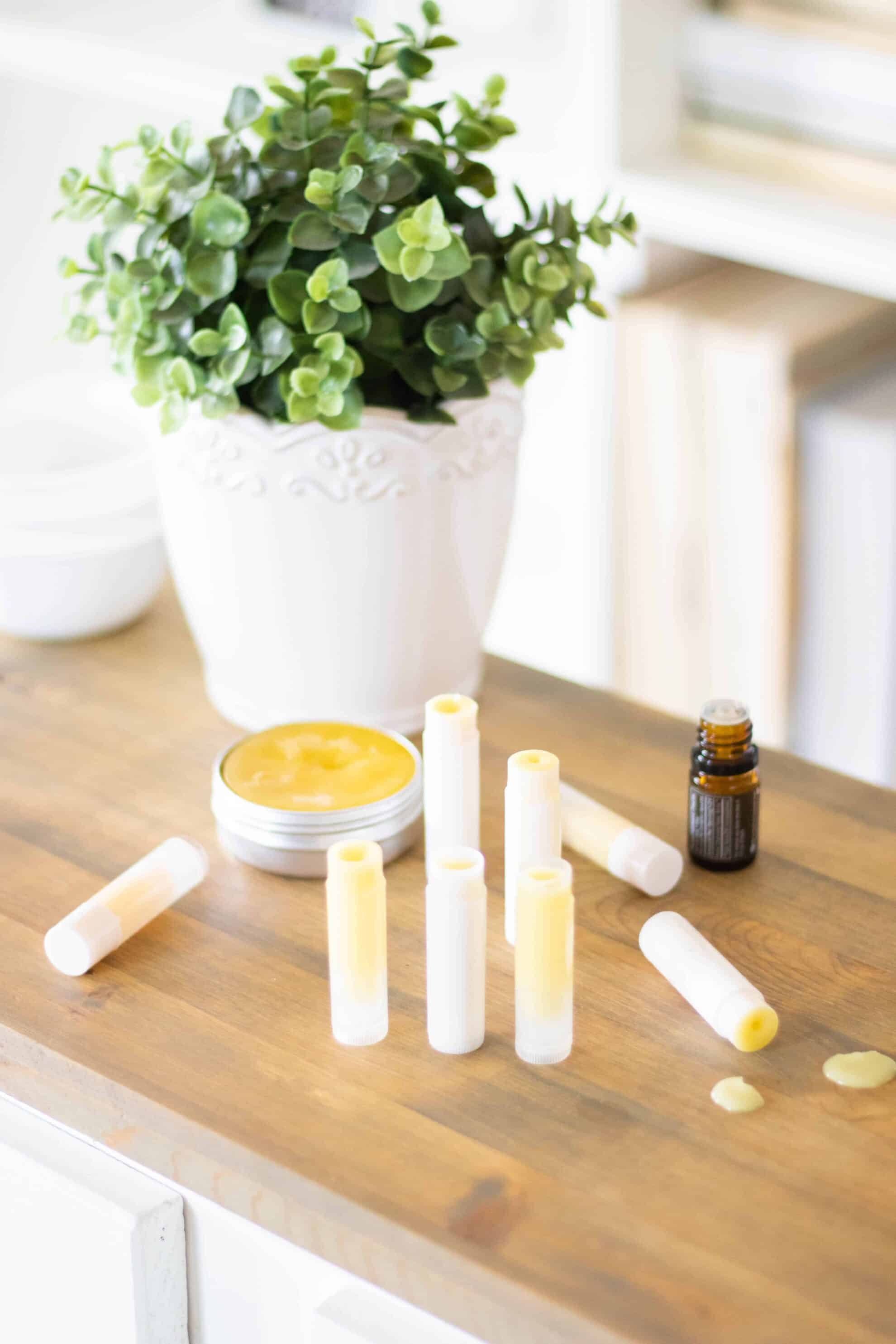 Anti itch cream in lip balm tubes on wooden table.