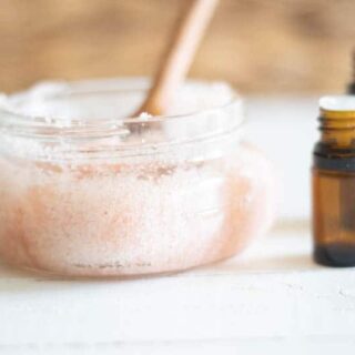 Diy foot scrub with pink salt and essential oils in small shallow glass contanier.