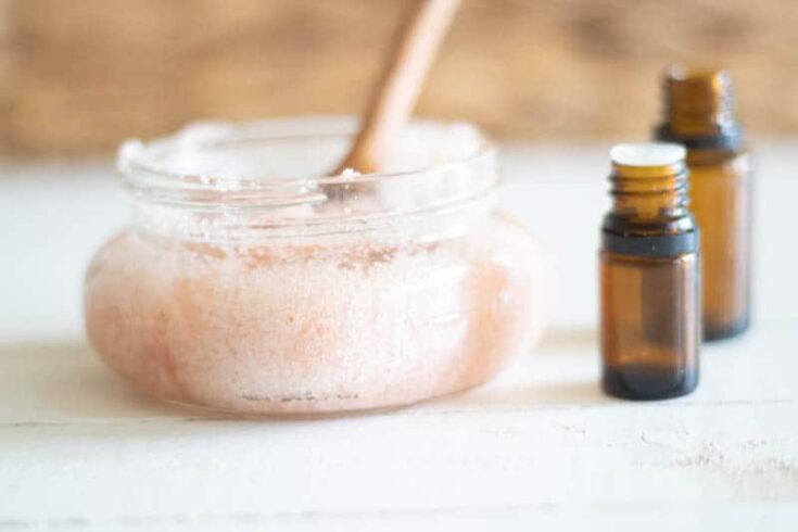 Diy foot scrub with pink salt and essential oils in small shallow glass contanier.