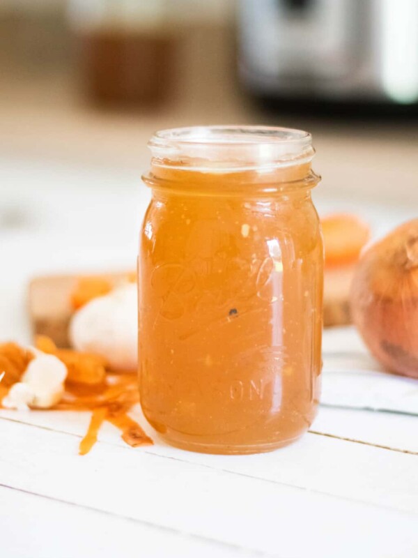 homemade bone broth in tall glass mason jar.