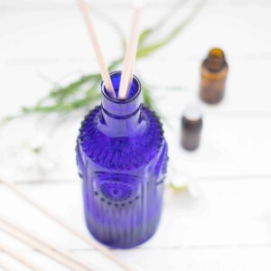 blue with vase with reeds on white ship lap