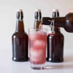 grape water kefir being poured into glass