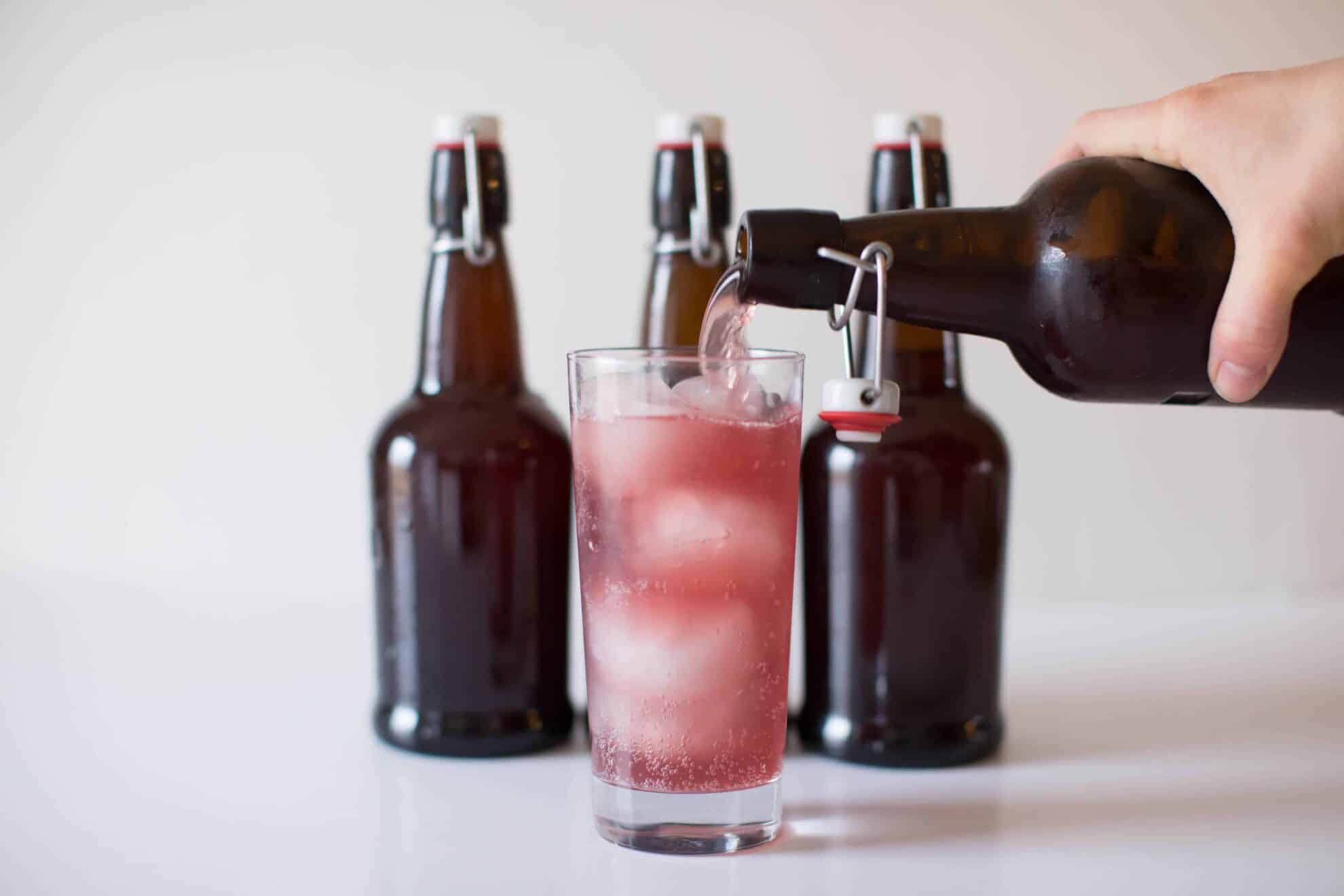 Fermented grape water kefir being poured into glass cup.