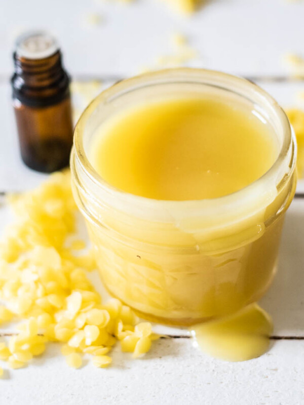 yellow beeswax sprinkled around small mason jar of homemade vapor rub.