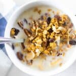 granola cereal and milk in white bowl