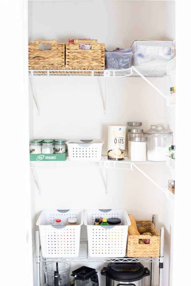 Clutter free pantry with storage containers on shelves.