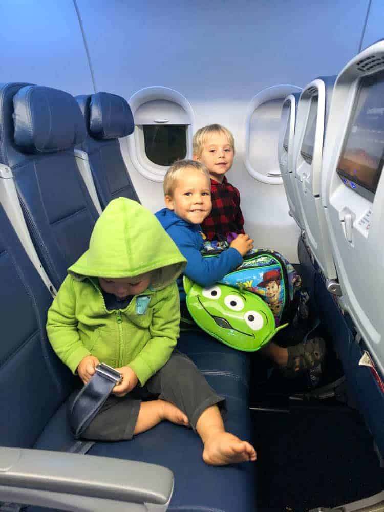 Three young boys on an airplane.