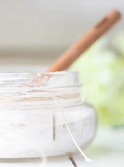 small mason jar of fizzing bath salts with wooden spoon.