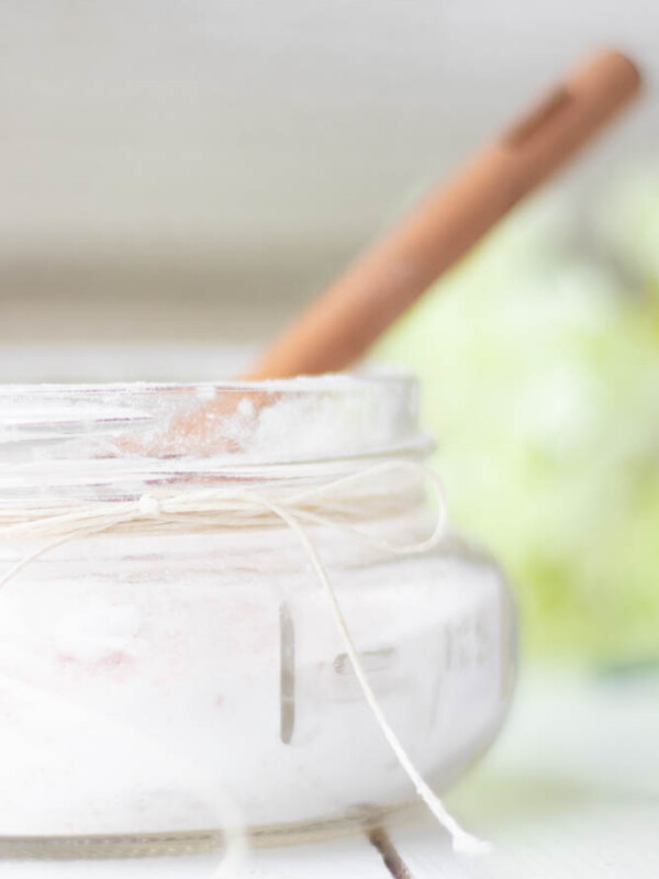 small mason jar of fizzing bath salts with wooden spoon.