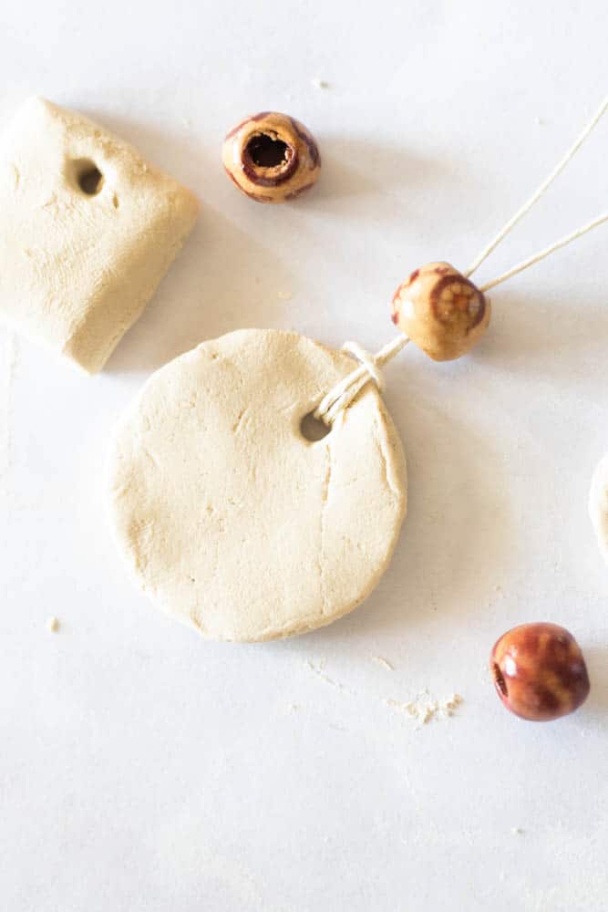 Beads being added to a homemade DIY diffuser necklaces.