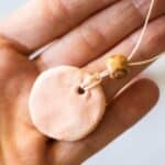 clay diffuser necklace in palm of hand