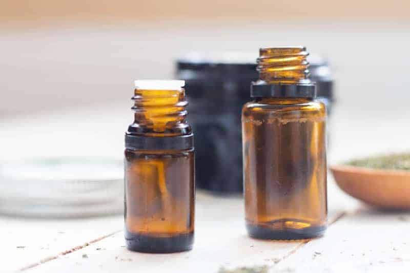 Essential oils in small bottles ready to add to the black draw salve recipe.