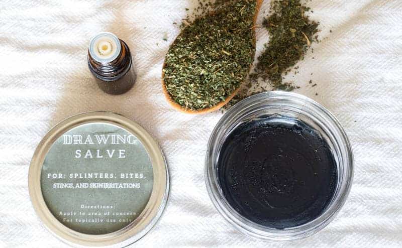 A handmade draw salve with an airtight lid and a handmade label.