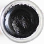 DIY black draw salve cooling in a clear container.