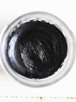 DIY black draw salve cooling in a clear container.