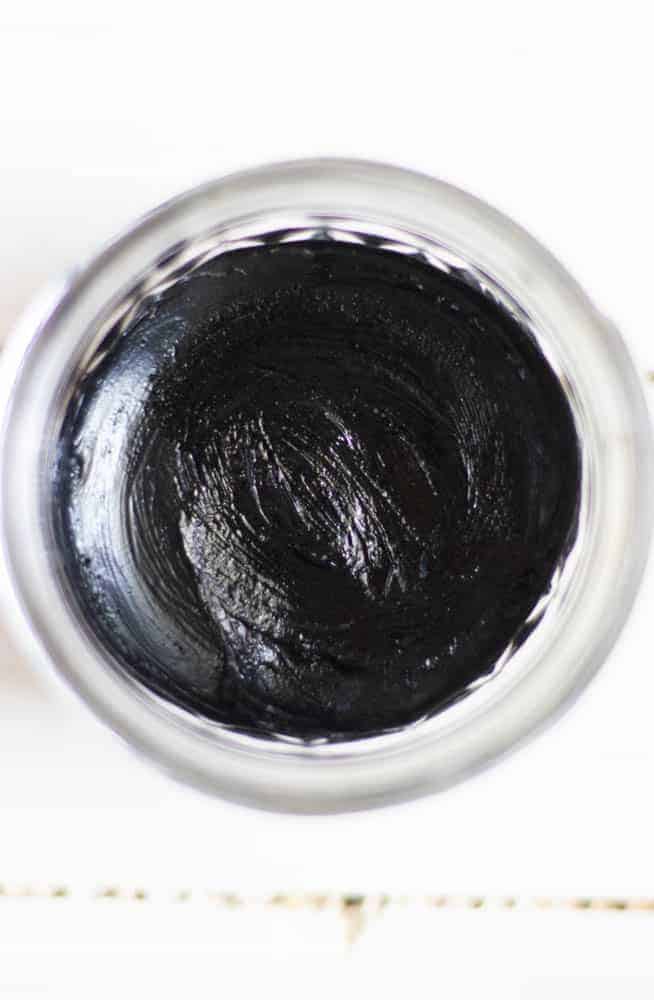 DIY black draw salve cooling in a clear container.