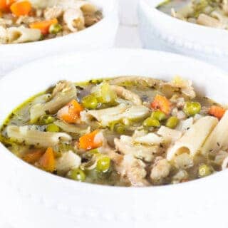 turkey noodle vegetable soup in white bowls