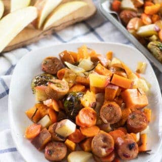 white plate of roasted sausage and vegetables