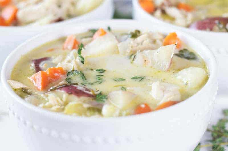 Whole 30 creamy chicken soup in white bowl.