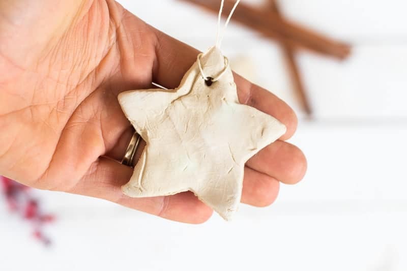 Holding a homemade essential oil diffuser white star shaped ornament.