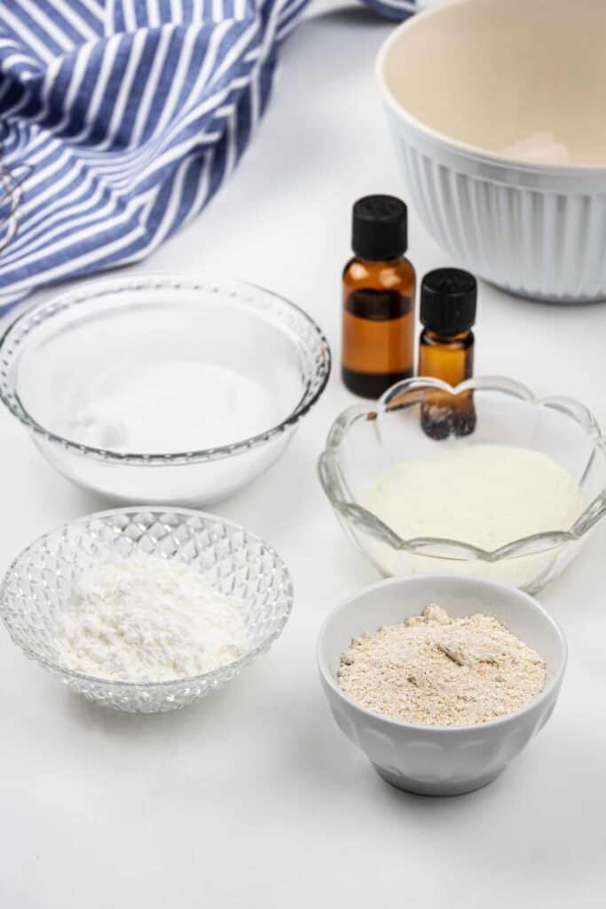 Powders in bowls and amber essential oil bottles.