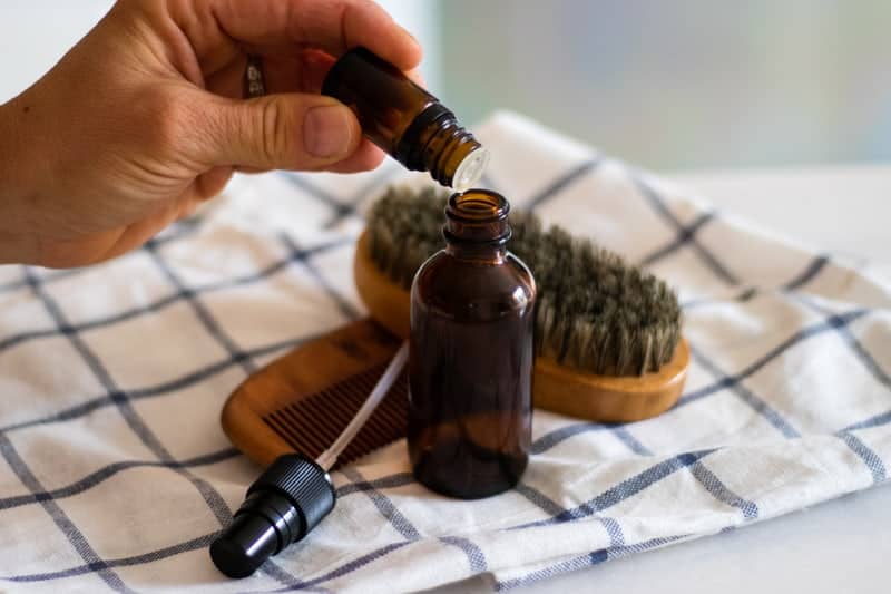 Adding essential oils to the DIY aftershave bottle. 