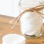 makeup wipes in mason jar and on wood table.